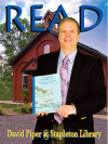 Dr. David Piper in front of school house