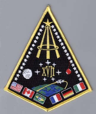 Many symbols make up the 17th NASA class patch: 31 members/ 31 diagonal silver stars, 6 flags/ 6 countries represented, 7 stars circling roman numerals/ 7 original astonauts.