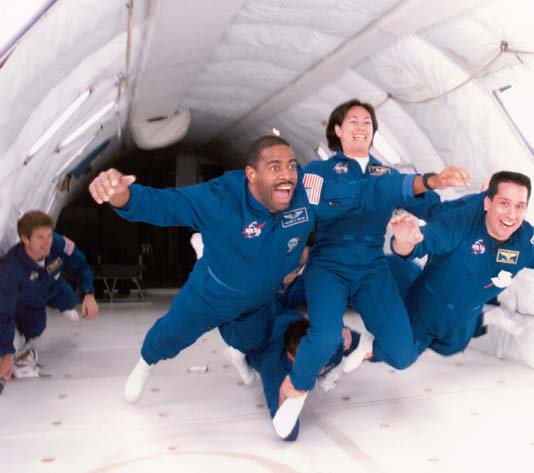 Patty along her 1998 class "The Penguins", having fun experiencing 0 gravity in the KC135, affectionately called the "vomit comet".