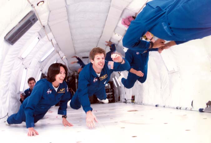 Patty along her 1998 class "The Penguins", having fun experiencing 0 gravity in the KC135, affectionately called the "vomit comet".