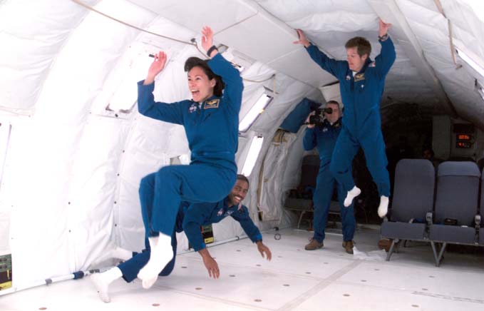 Patty along her 1998 class "The Penguins", having fun experiencing 0 gravity in the KC135, affectionately called the "vomit comet".