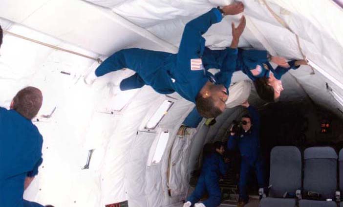Patty along her 1998 class "The Penguins", having fun experiencing 0 gravity in the KC135, affectionately called the "vomit comet".