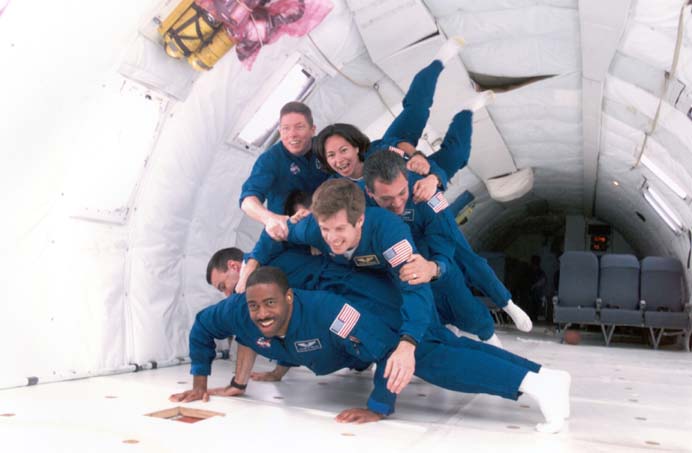 Patty along her 1998 class "The Penguins", having fun experiencing 0 gravity in the KC135, affectionately called the "vomit comet".
