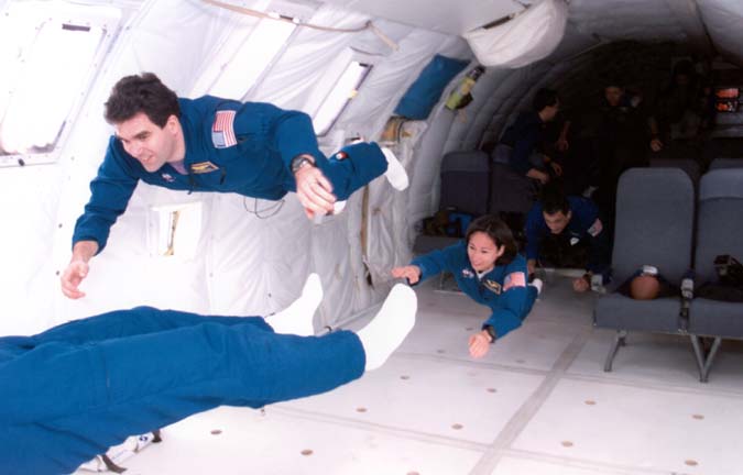 Patty along her 1998 class "The Penguins", having fun experiencing 0 gravity in the KC135, affectionately called the "vomit comet".